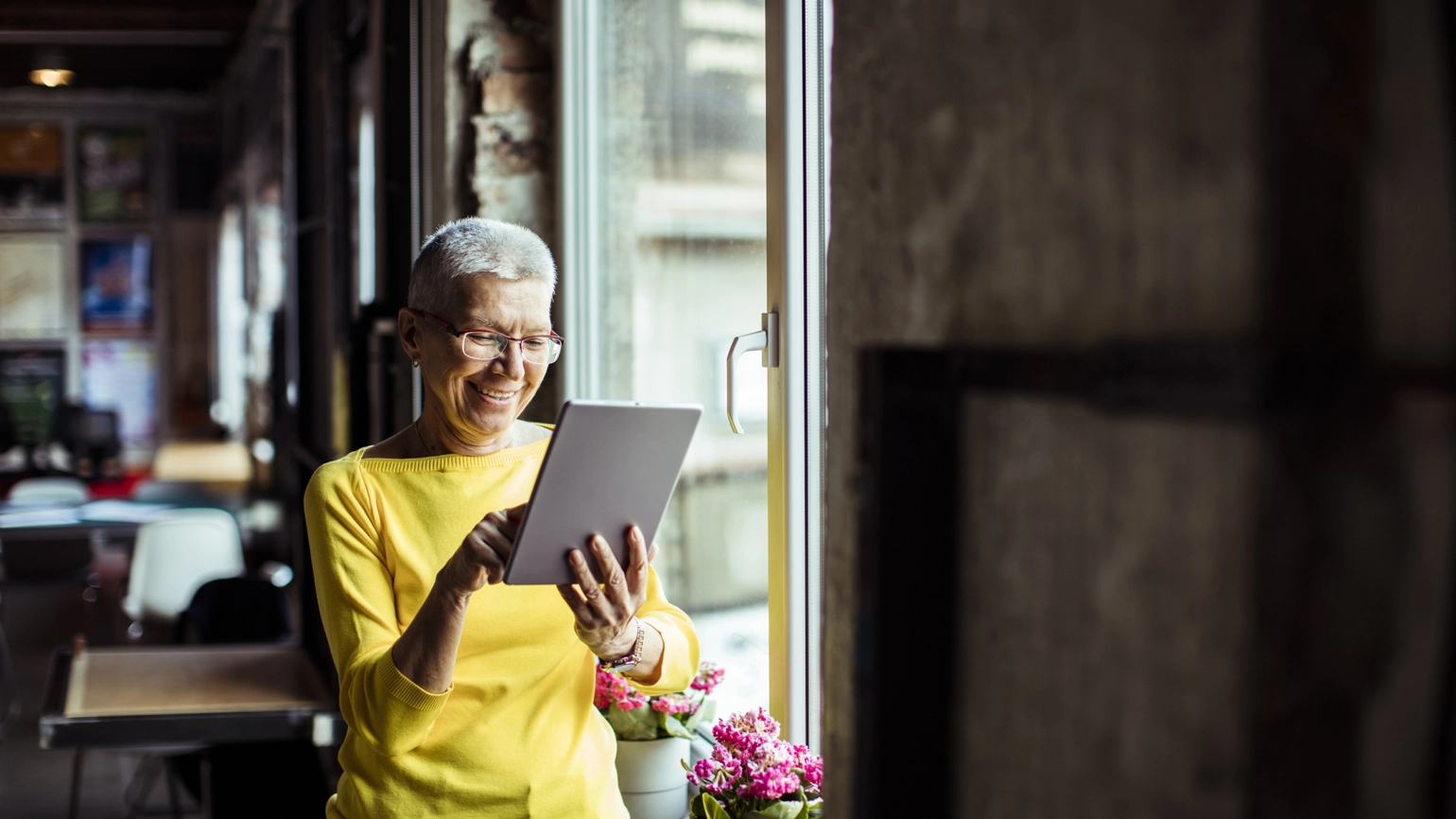 Photo of elderly female using touchpad Photo of elderly female using touchpad