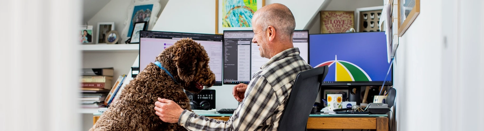 Man sitting at desk with computer screen showing L&G logo Man sitting at desk with computer screen showing L&G logo