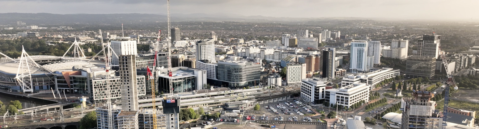 Aerial shot of central Cardiff, UK, with construction cranes in sight. Aerial shot of central Cardiff, UK, with construction cranes in sight.