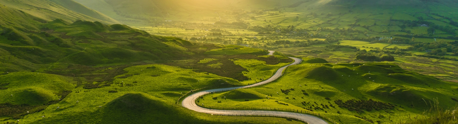 Road winding through green hills, Derbyshire, UK. Road winding through green hills, Derbyshire, UK.